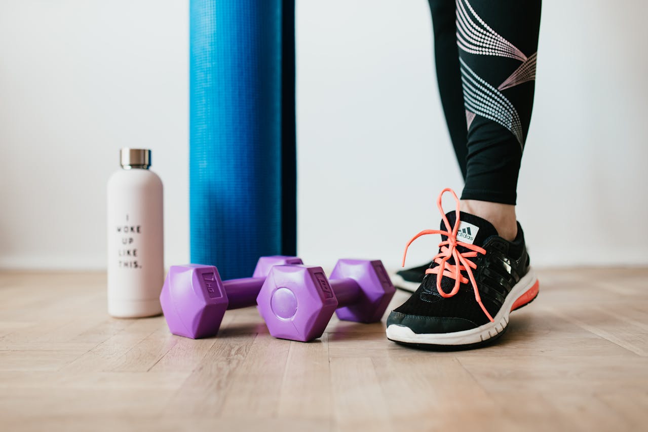 Woman-standing-near-gym-accessories